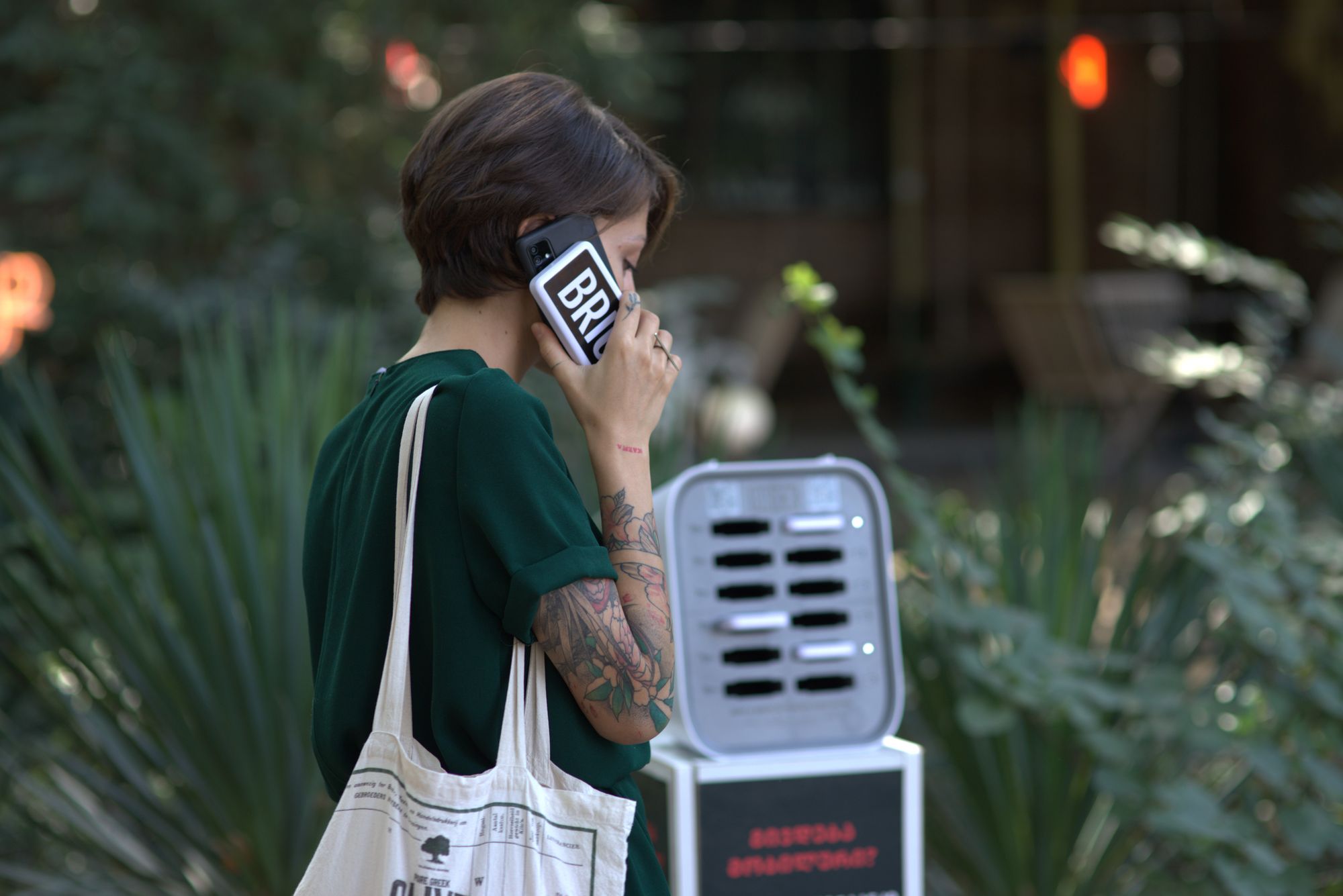 A person talking on the phone while charging with a Brick powerbank.